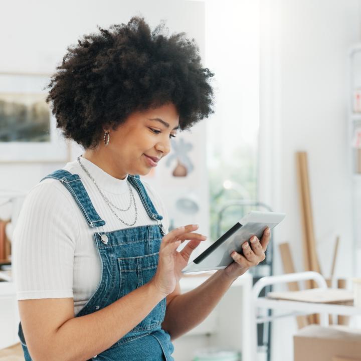 black-woman-online-shopping-and-tablet-at-warehouse